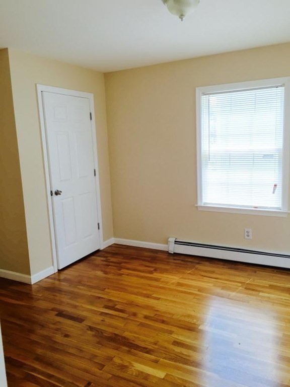 31-35 Juniper Street Boston, MA 02119 - Photo 10 of 14 a view of an empty room with wooden floor and a window