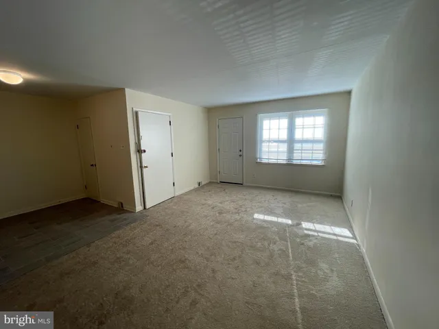 an empty room with a empty space and window