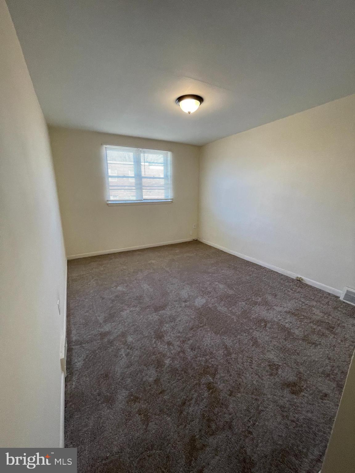 3937 Ellington Road, Unit 2 Philadelphia, PA 19131 - Photo 8 of 17 an empty room with windows