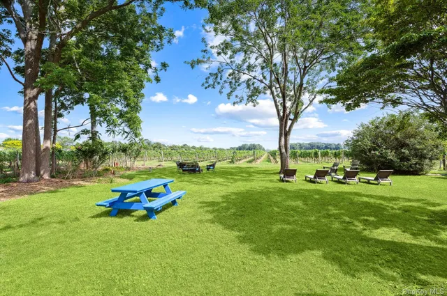 a backyard of a house with table and chairs