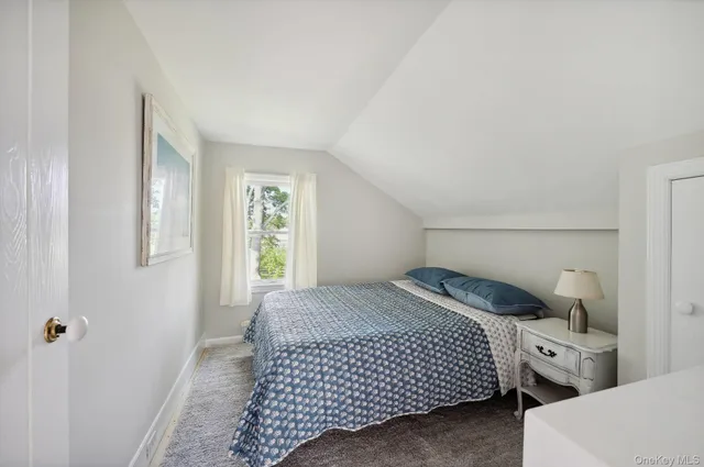 a bedroom with a bed and a table in it