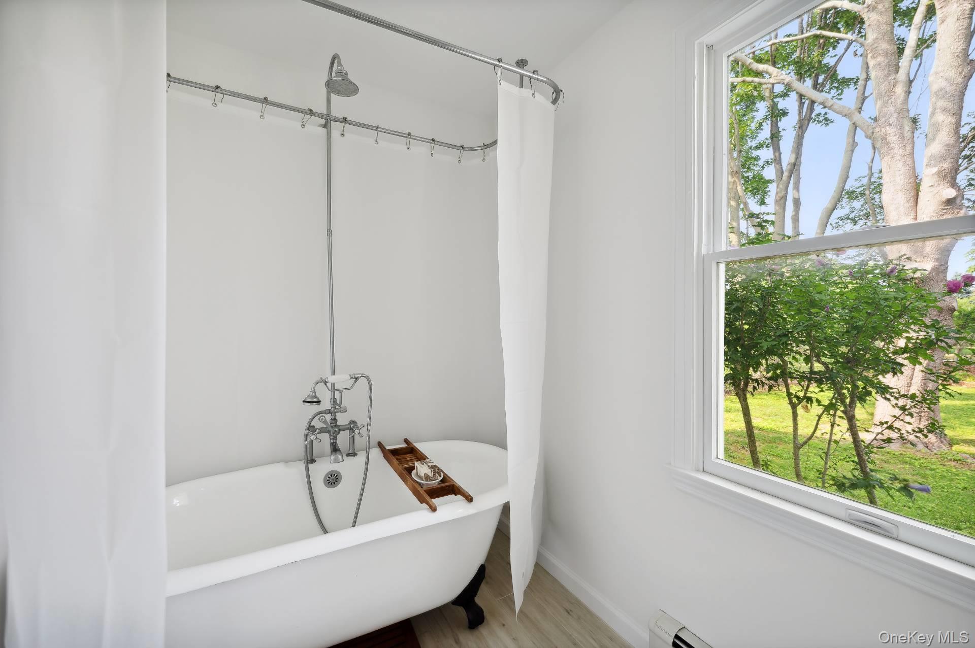 2600 Oregon Road Mattituck, NY 11952 - Photo 28 of 30 a bathroom with a bathtub and window