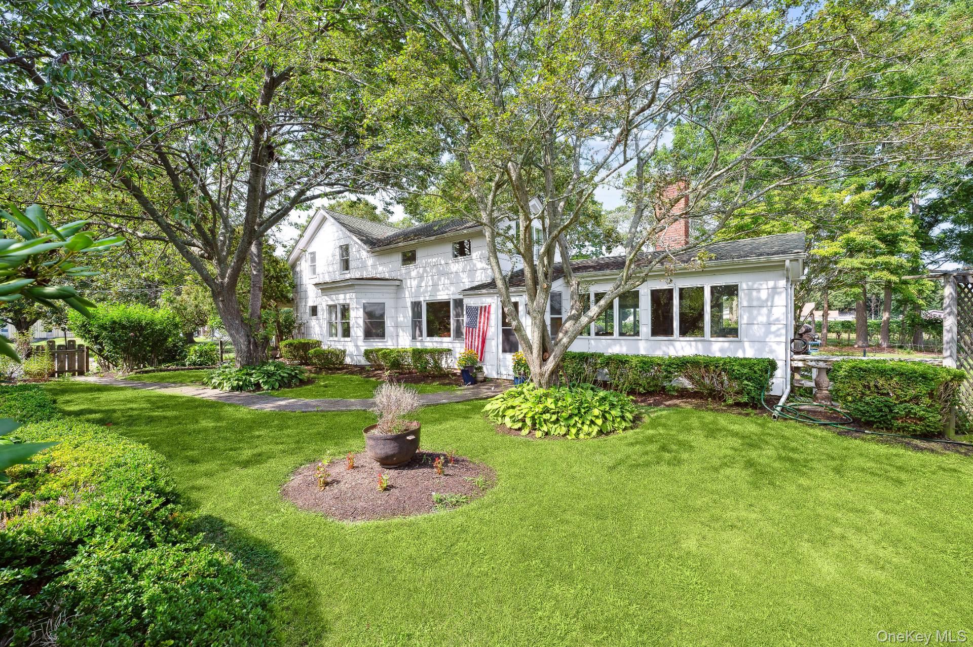 2600 Oregon Road Mattituck, NY 11952 - Photo 5 of 30 a front view of a house with a yard and trees