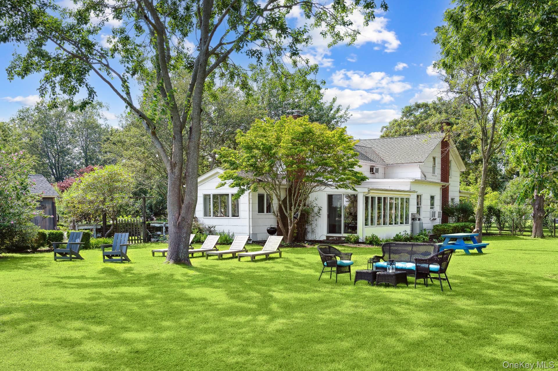 2600 Oregon Road Mattituck, NY 11952 - Photo 6 of 30 a view of a house with a big yard and sitting area