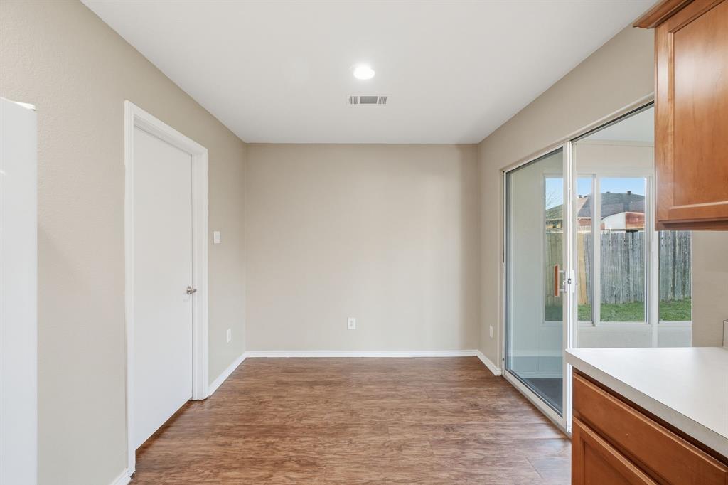 111 Maned Drive Sanger, TX 76266 - Photo 12 of 40 a view of hallway with a front door and wooden floor