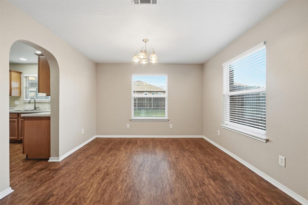 111 Maned Drive Sanger, TX 76266 - Photo 15 of 40 an empty room with wooden floor and windows
