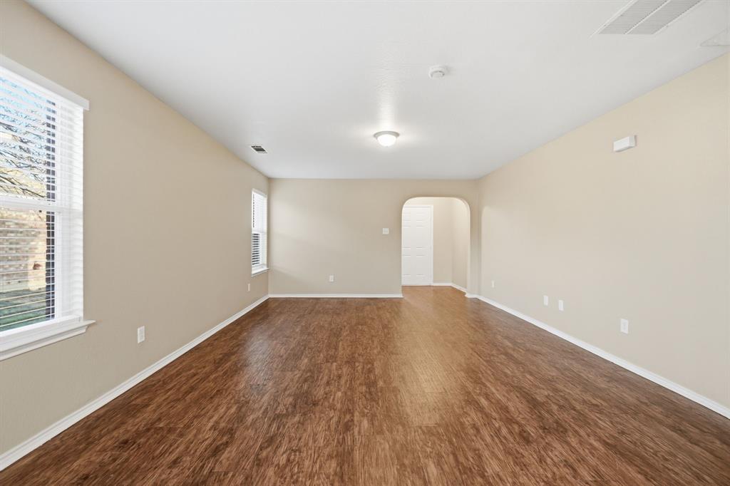 111 Maned Drive Sanger, TX 76266 - Photo 16 of 40 a view of empty room with wooden floor and fan