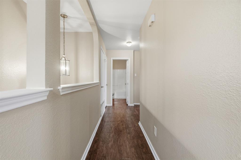 111 Maned Drive Sanger, TX 76266 - Photo 18 of 40 a view of a hallway with wooden floor and a window