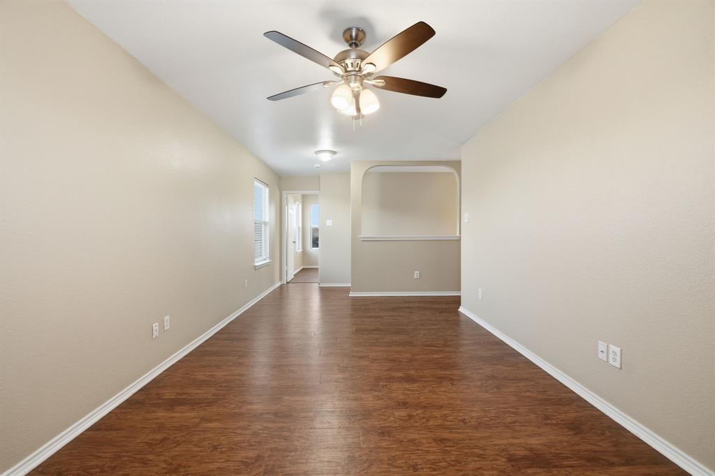 111 Maned Drive Sanger, TX 76266 - Photo 19 of 40 an empty room with wooden floor and ceiling fan