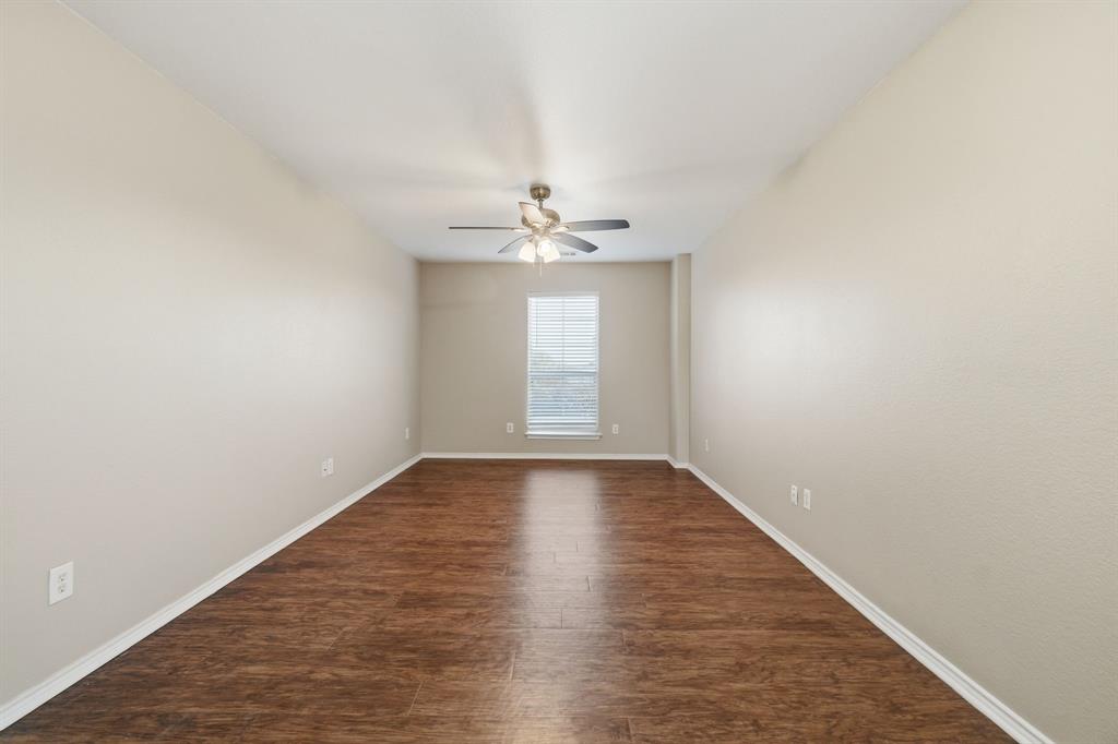 111 Maned Drive Sanger, TX 76266 - Photo 20 of 40 an empty room with wooden floor and windows