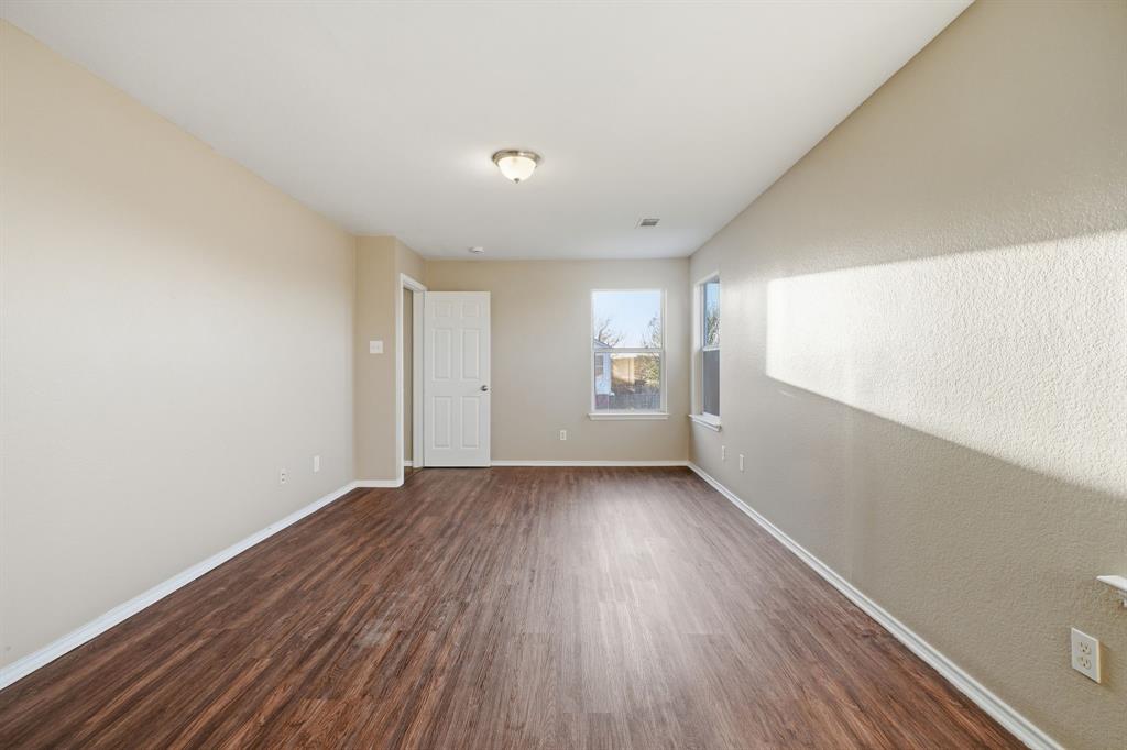 111 Maned Drive Sanger, TX 76266 - Photo 21 of 40 an empty room with wooden floor and windows