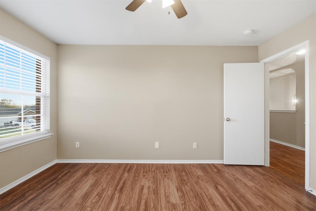 111 Maned Drive Sanger, TX 76266 - Photo 25 of 40 an empty room with wooden floor and windows