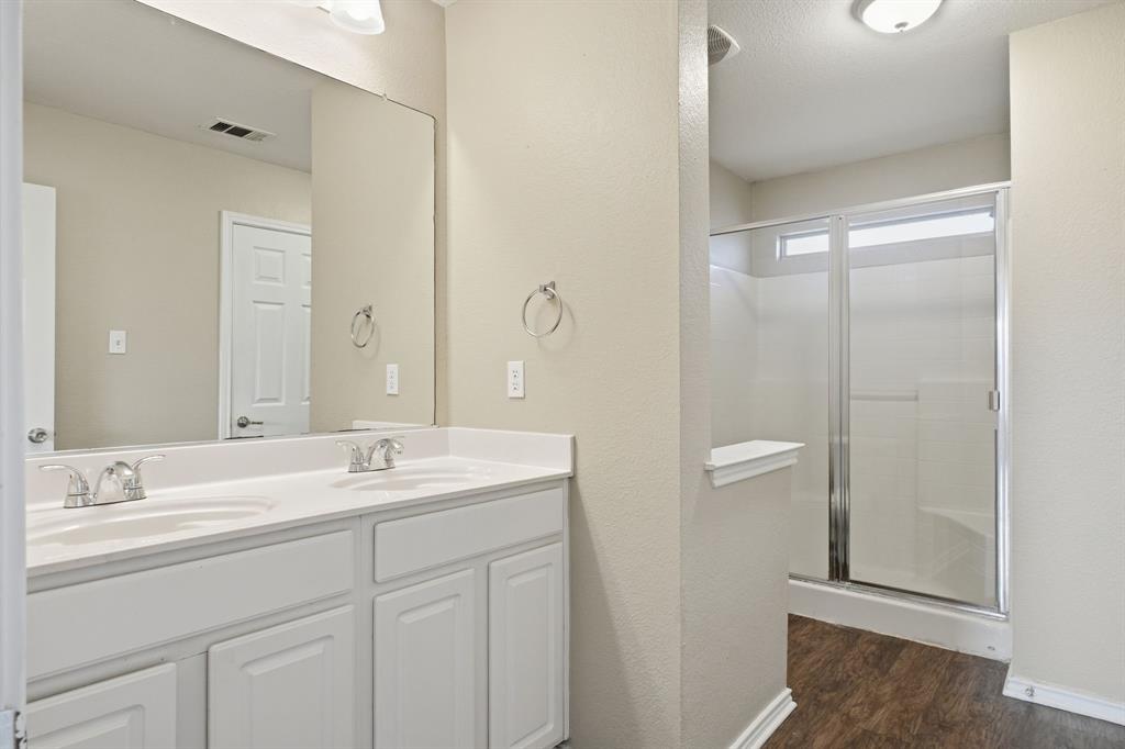 111 Maned Drive Sanger, TX 76266 - Photo 30 of 40 a bathroom with a double vanity sink and mirror
