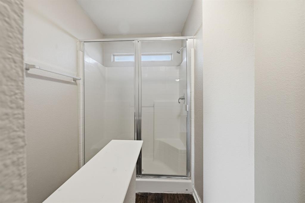 111 Maned Drive Sanger, TX 76266 - Photo 31 of 40 a bathroom with a glass shower door