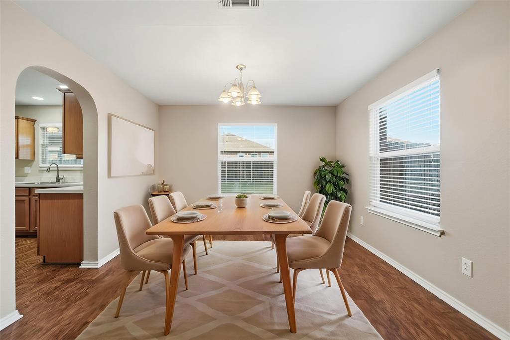 111 Maned Drive Sanger, TX 76266 - Photo 4 of 40 a dining room with furniture a chandelier and wooden floor