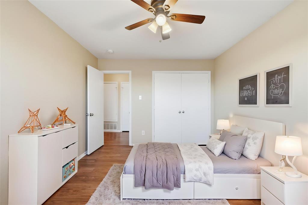 111 Maned Drive Sanger, TX 76266 - Photo 7 of 40 a bedroom with a bed and a chandelier