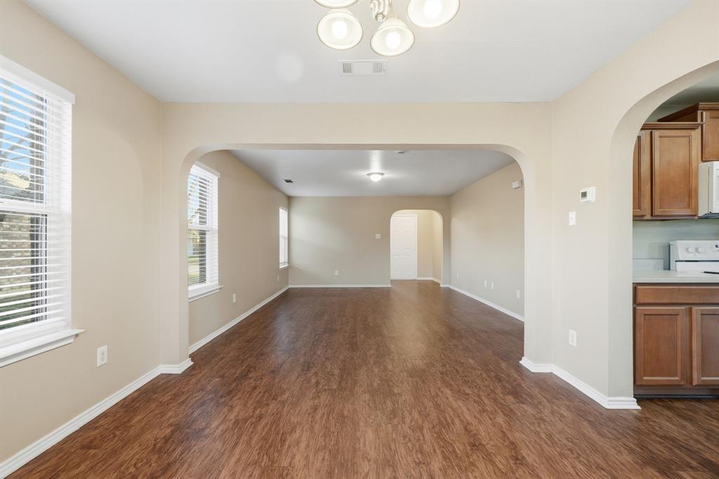 111 Maned Drive Sanger, TX 76266 - Photo 9 of 40 a view of empty room with wooden floor and fan