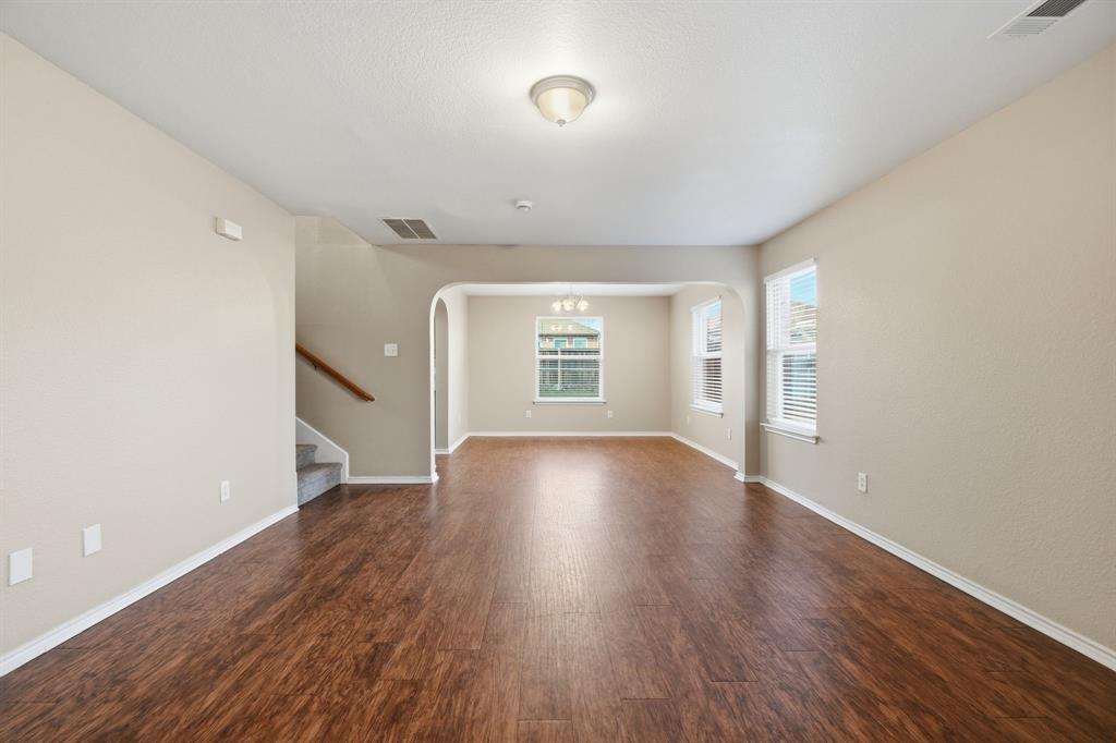 111 Maned Drive Sanger, TX 76266 - Photo 10 of 40 an empty room with wooden floor and windows