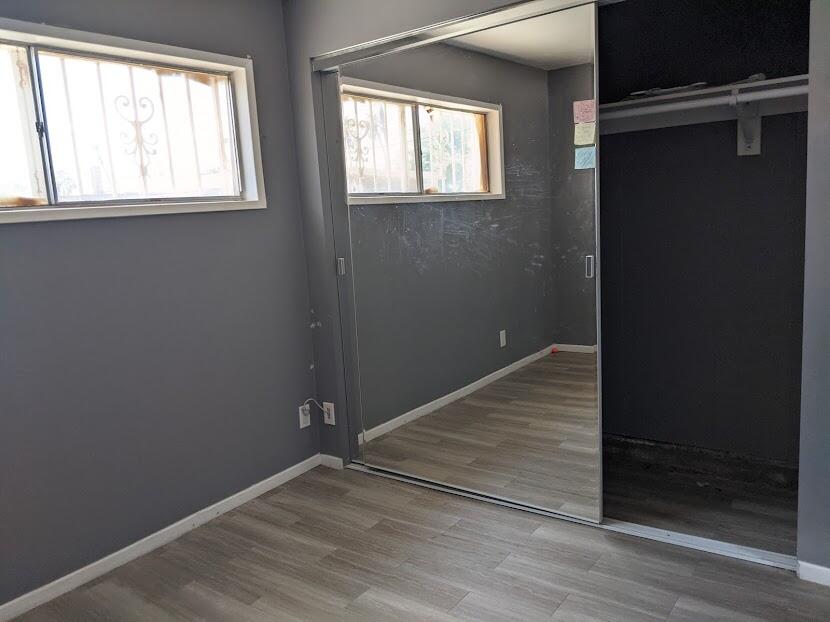 82181 Miles Avenue Indio, CA 92201 - Photo 17 of 21 an empty room with wooden floor and windows