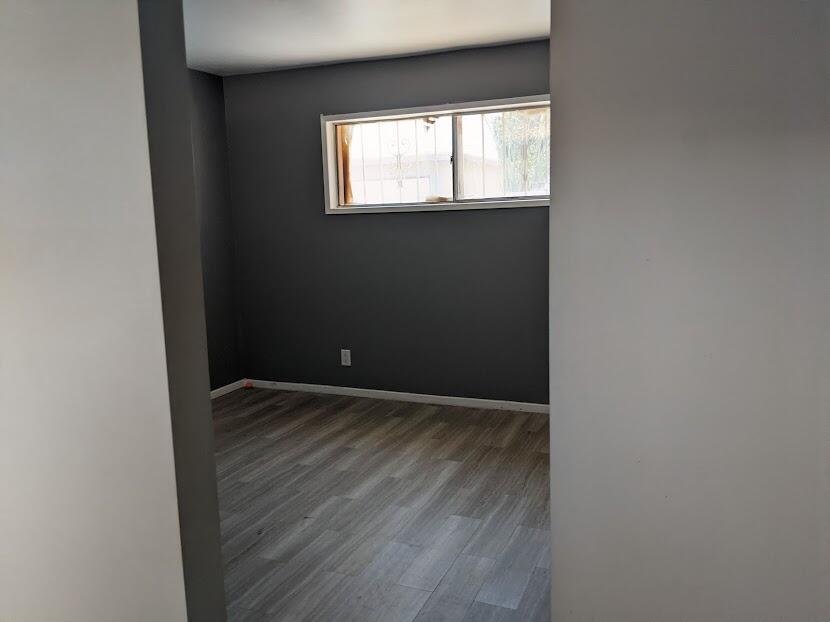 82181 Miles Avenue Indio, CA 92201 - Photo 18 of 21 a view of an empty room with wooden floor and a window