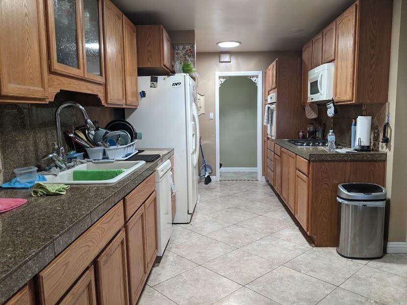 82181 Miles Avenue Indio, CA 92201 - Photo 6 of 21 a kitchen with stainless steel appliances granite countertop a stove top oven a sink dishwasher and a refrigerator