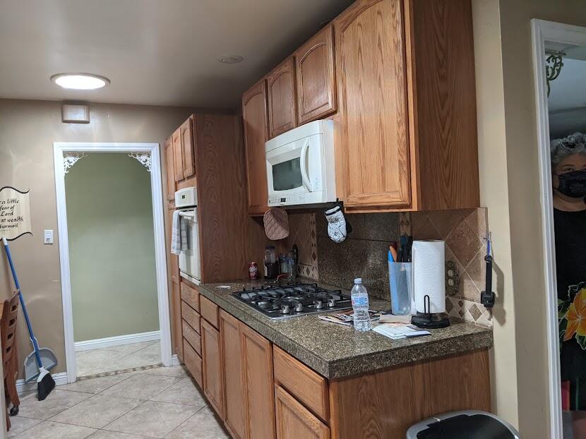 82181 Miles Avenue Indio, CA 92201 - Photo 7 of 21 a kitchen with stainless steel appliances granite countertop a stove a sink and a microwave