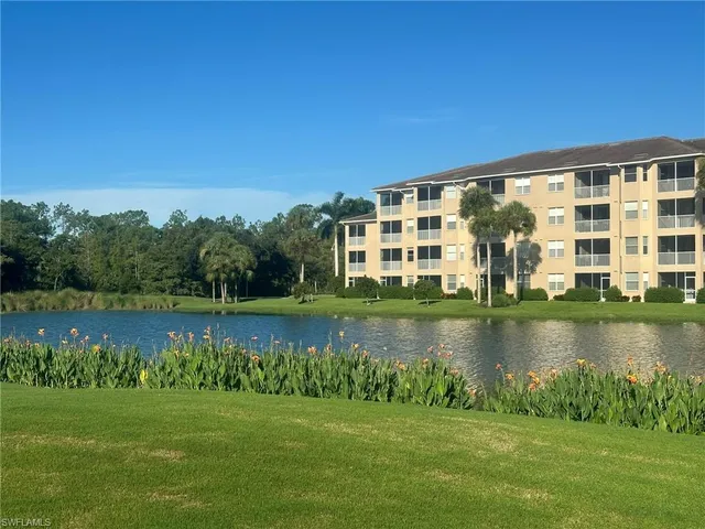 a view of a lake with houses in the background