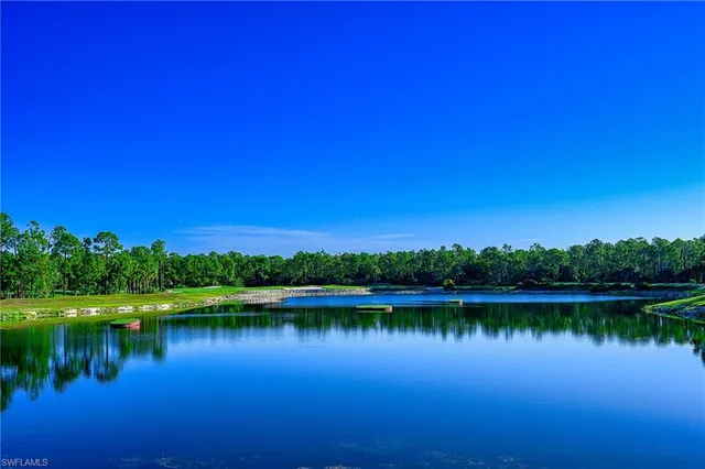 a view of a lake with houses in the background