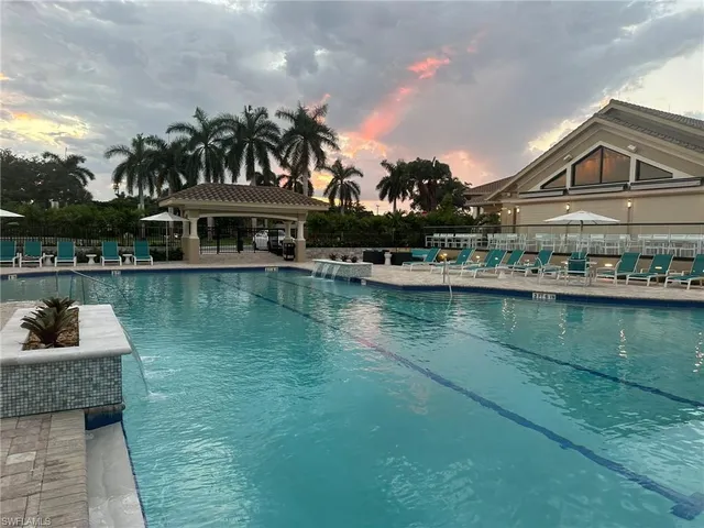a view of a house with swimming pool and a yard