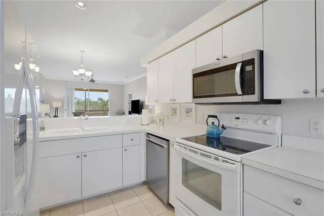 a kitchen with a sink stove and microwave