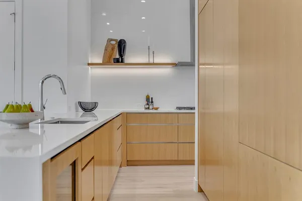 a kitchen with a sink a refrigerator and cabinets