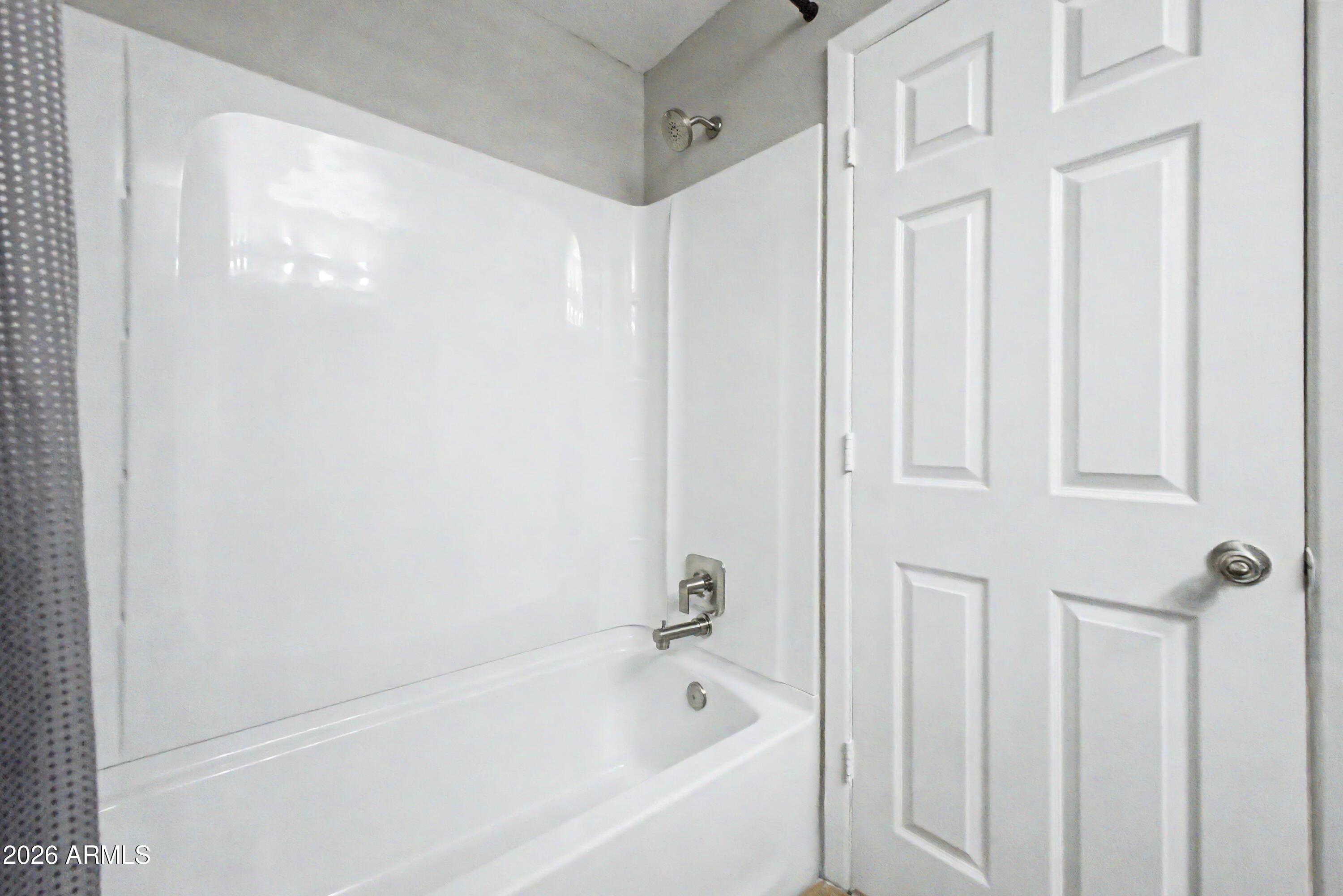 424 West Brown Road, Unit 248 Mesa, AZ 85201 - Photo 15 of 19 a white bath tub sitting next to a shower