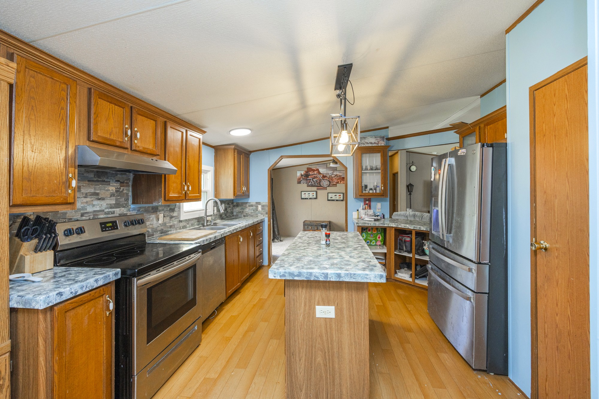 8591 Lowe Christiana Road Christiana, TN 37037 - Photo 11 of 37 a kitchen with stainless steel appliances granite countertop a stove and refrigerator