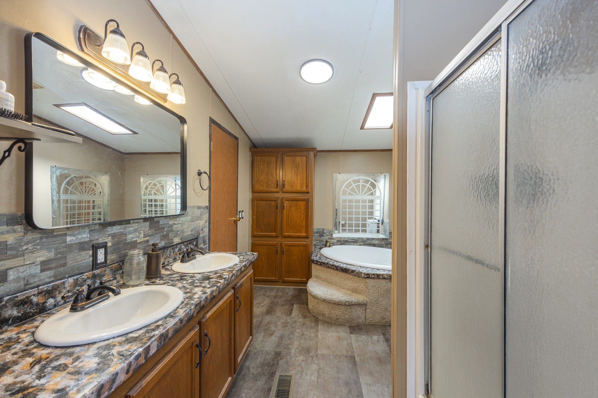 8591 Lowe Christiana Road Christiana, TN 37037 - Photo 16 of 37 a bathroom with a granite countertop sink and a mirror