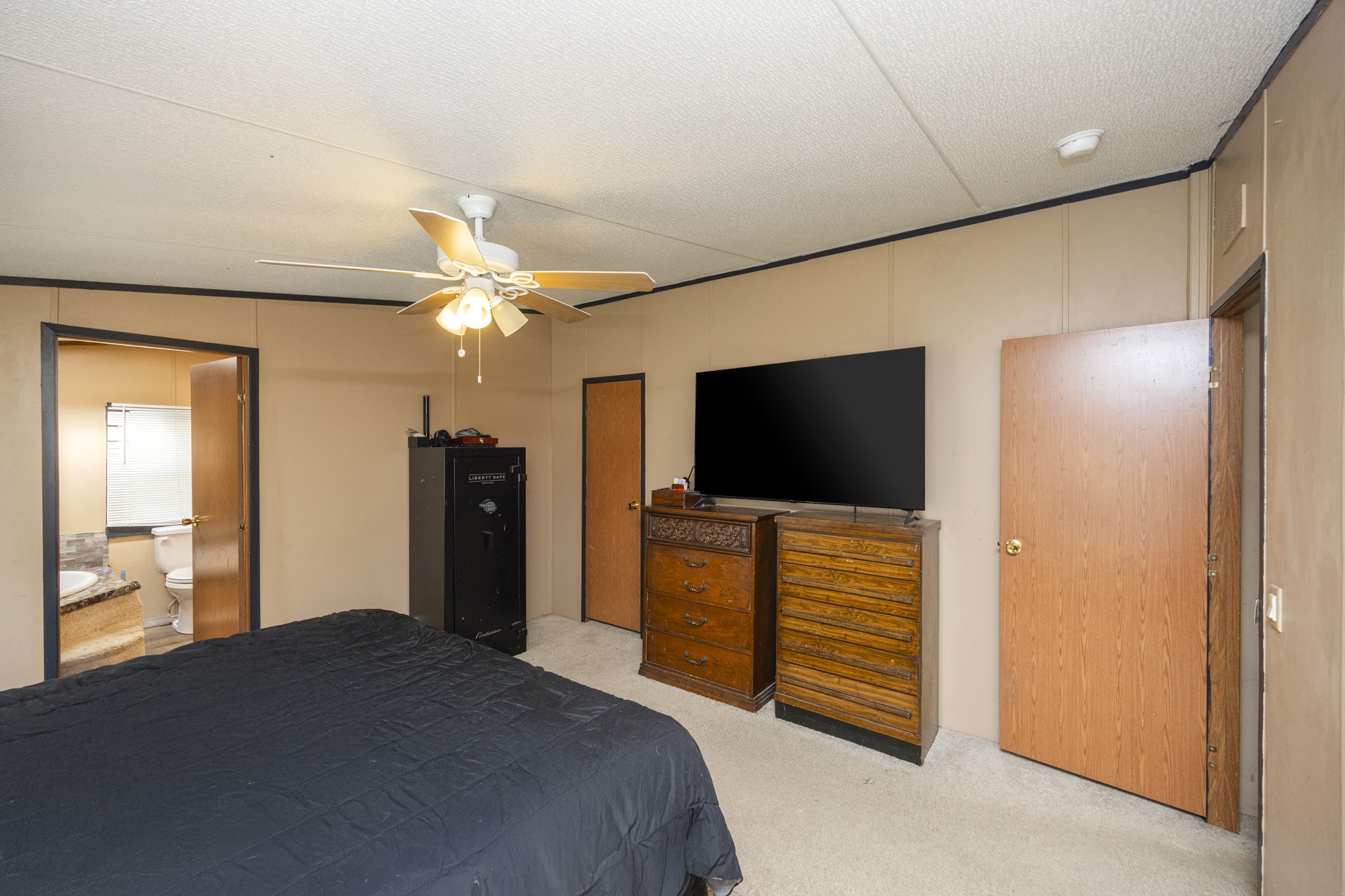 8591 Lowe Christiana Road Christiana, TN 37037 - Photo 19 of 37 a bedroom with a bed and a flat screen tv