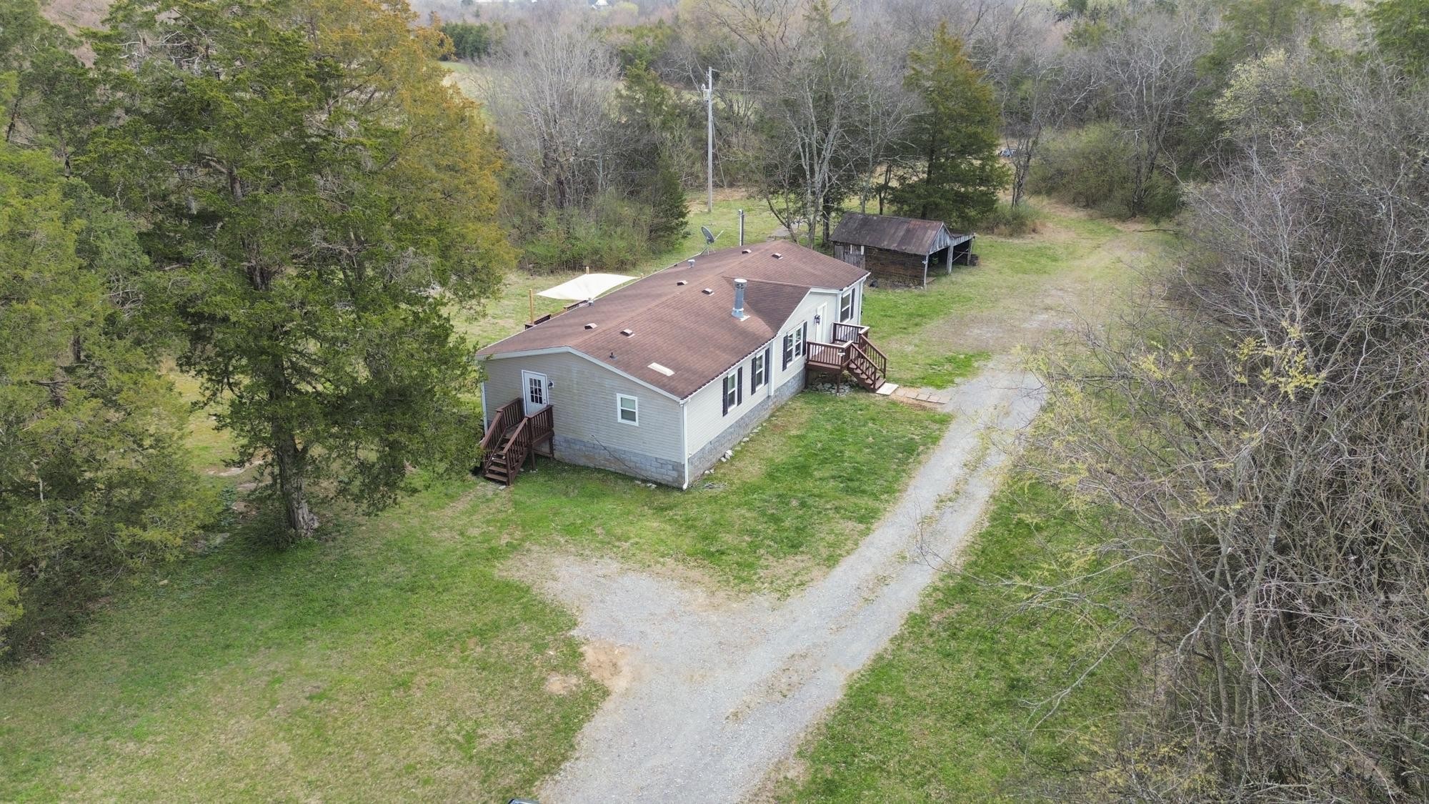 8591 Lowe Christiana Road Christiana, TN 37037 - Photo 33 of 37 a view of a house with a yard