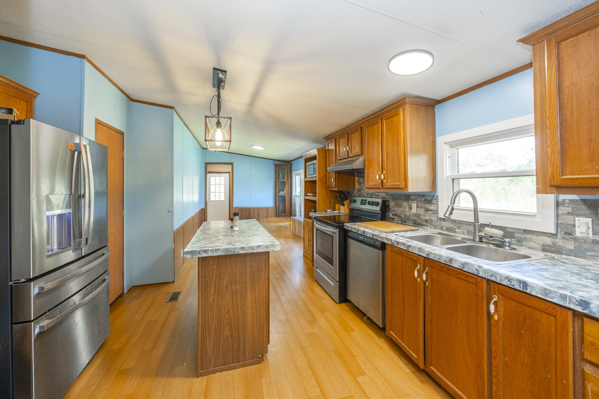 8591 Lowe Christiana Road Christiana, TN 37037 - Photo 6 of 37 a kitchen with stainless steel appliances granite countertop a sink stove and refrigerator
