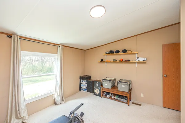 a bedroom with furniture and a window