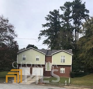 2005 Ben Hill Court Southwest Atlanta, GA 30331 - Photo 1 of 1 a front view of a residential apartment building with a yard and garage