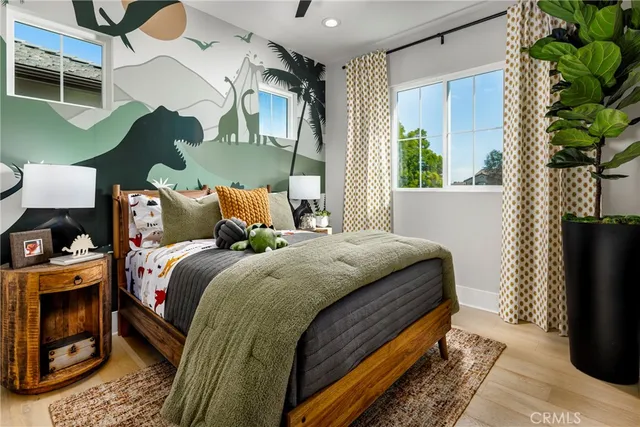 a bed sitting in a bedroom next to a window