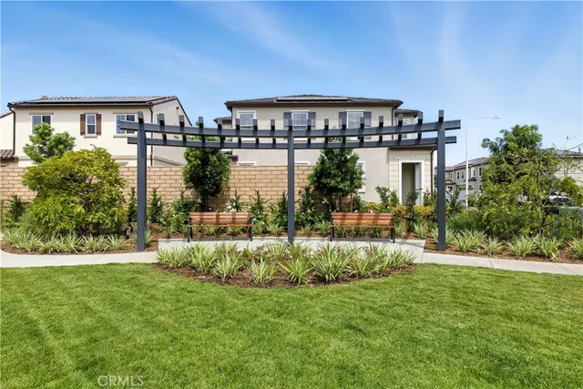 a front view of a house with a yard and lake view