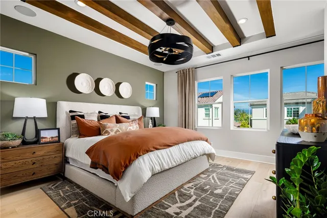 a bedroom with a bed and a large window with the outer view