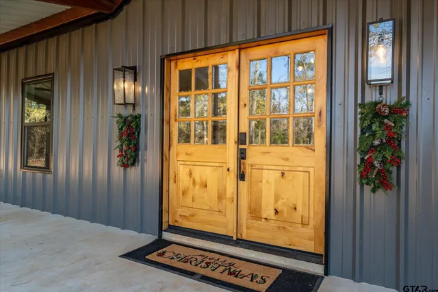 a living room with furniture a potted plant and a flat screen tv