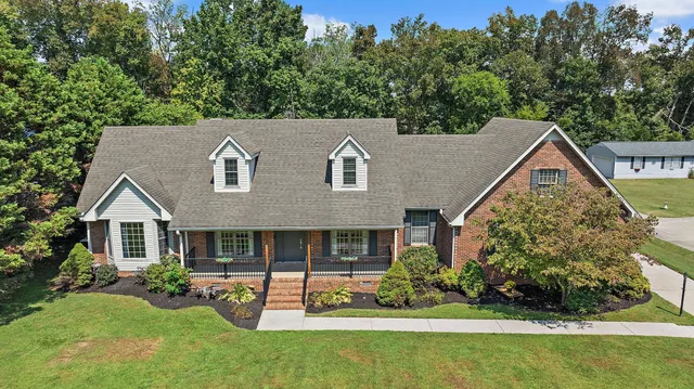 a aerial view of a house with swimming pool next to a big yard