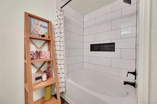 a bathroom with a bathtub and shower