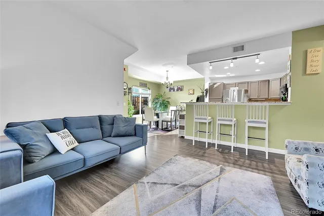 a living room with furniture a fireplace and a large window