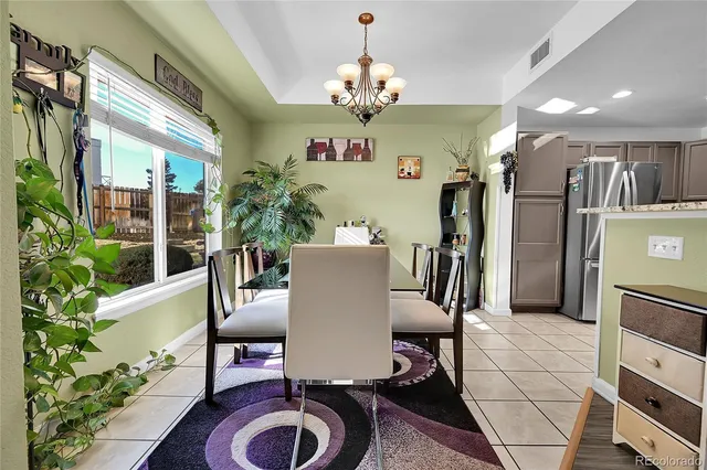 a view of a dining room with furniture and a chandelier