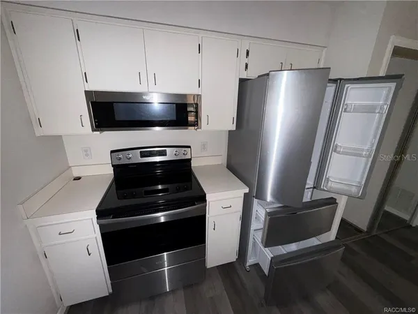 a kitchen with a stove and a refrigerator