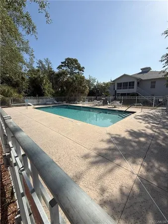 a view of a swimming pool with a yard