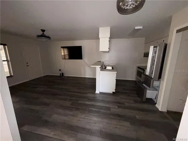 a view of a refrigerator and a table in a room